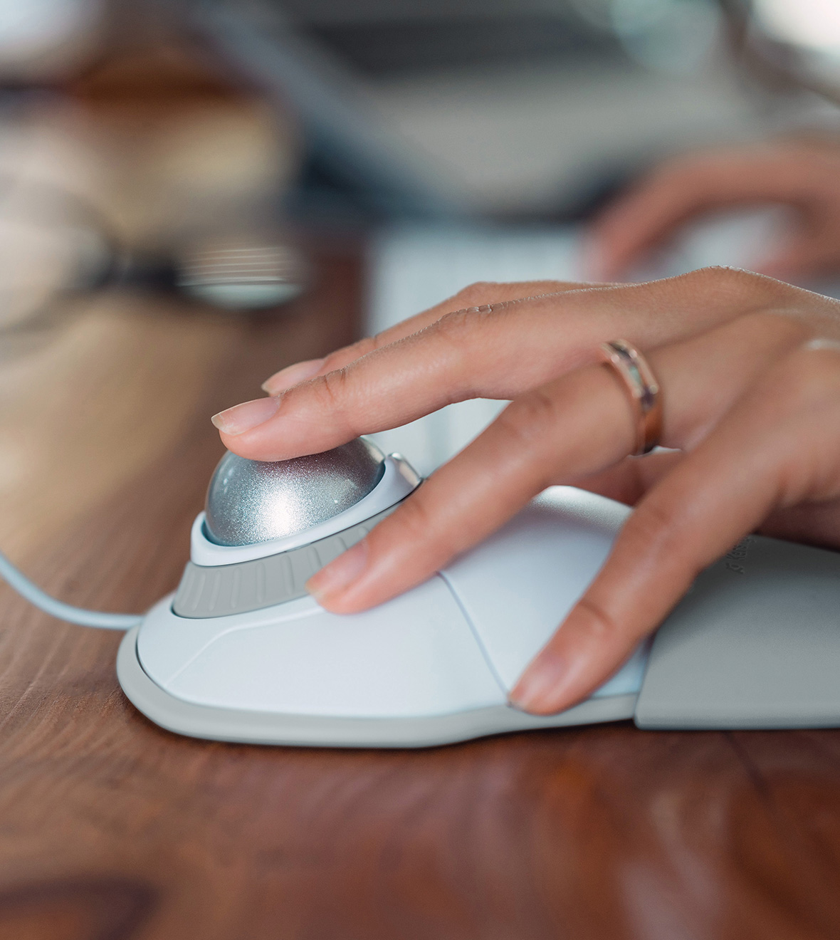 Closeup of woman using Kensington trackball