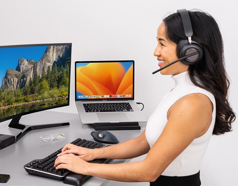 Woman talking through her Kensington H3000 headset.