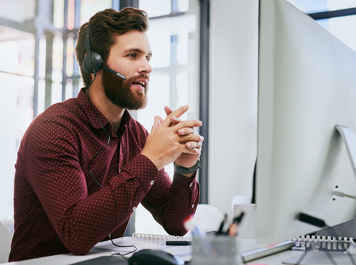 IT man speaking through his headphones.