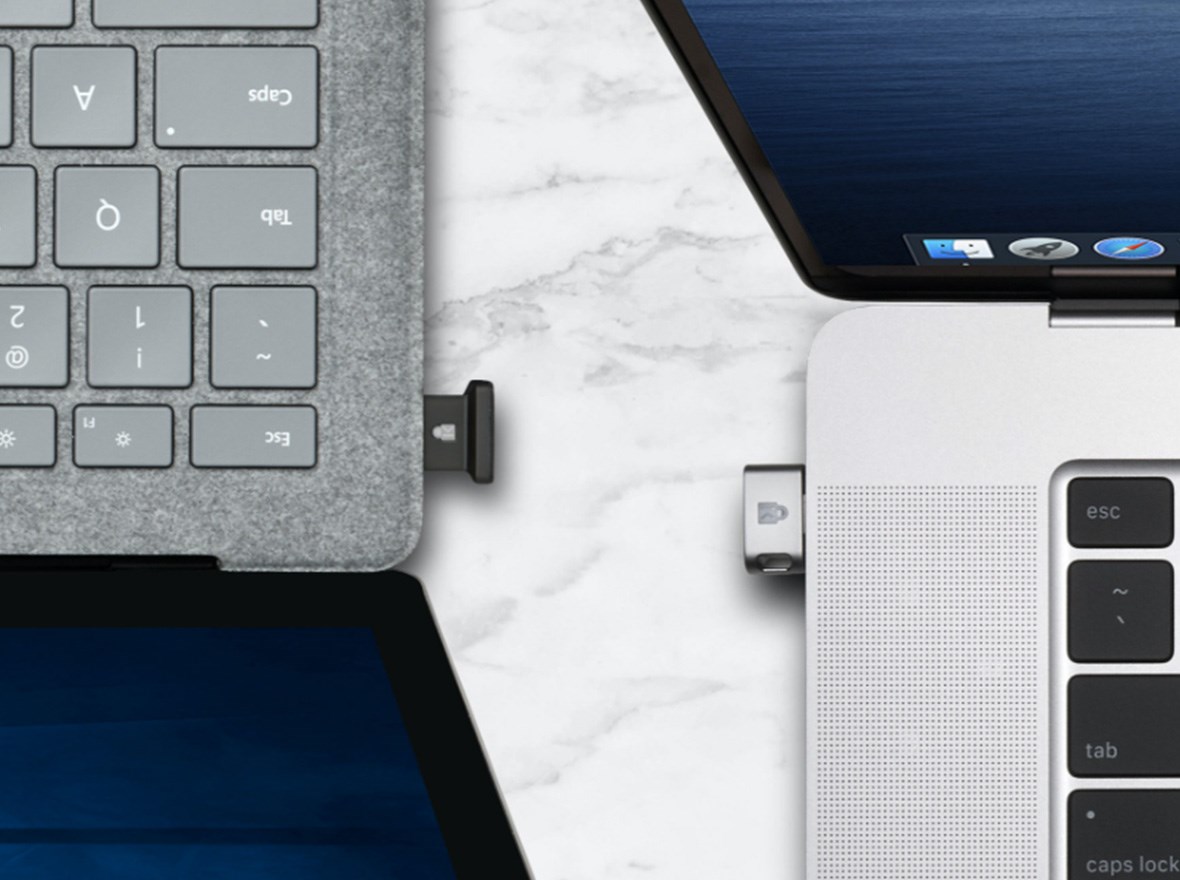 USB-A and USB-C® VeriMark™ Guard devices connected to 2 laptops.