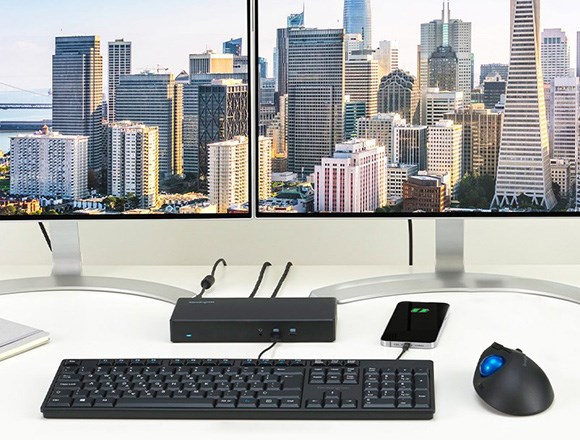 Pro desktop with 2 screens with buildings on the background.