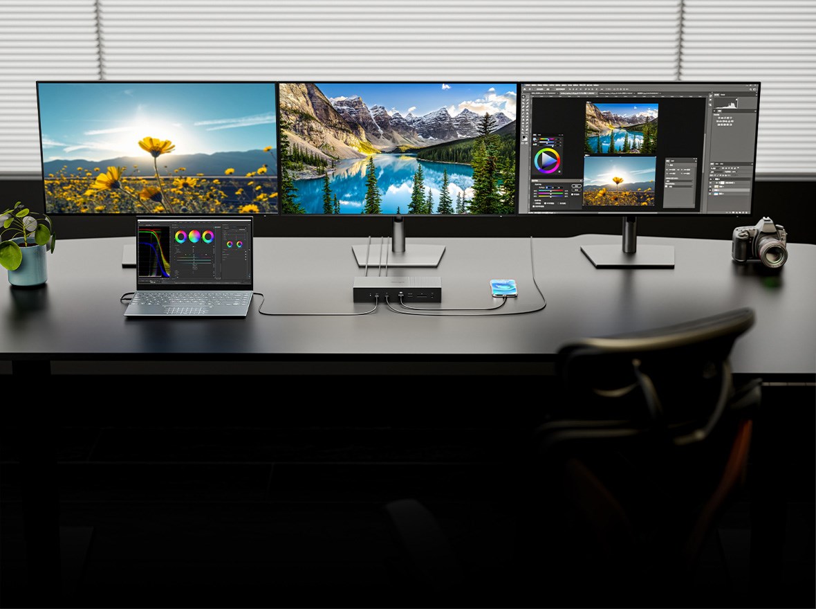 A multi-monitor setup for a professional, equipped with triple 4K displays, a laptop, a tablet, a camera, and a Kensington SD5000T5 EQ Thunderbolt 5 Docking Station. 